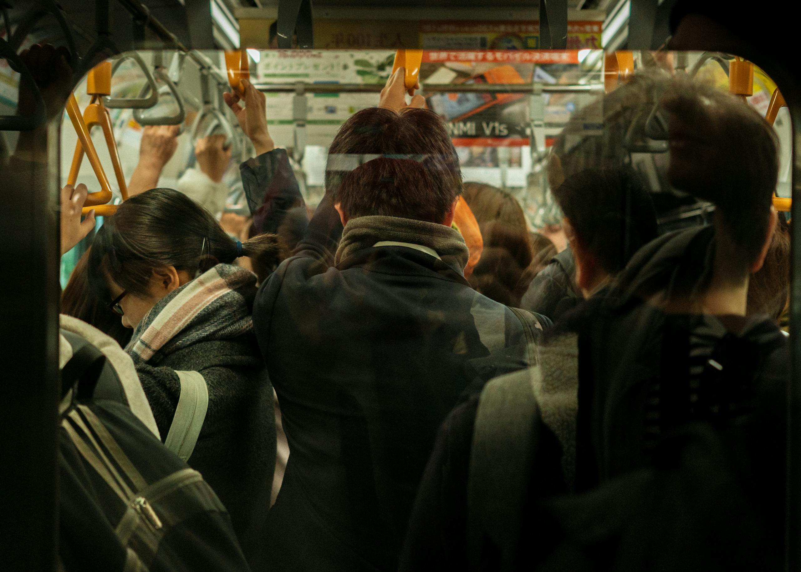 A busy Tokyo subway, capturing daily commute with diverse passengers.