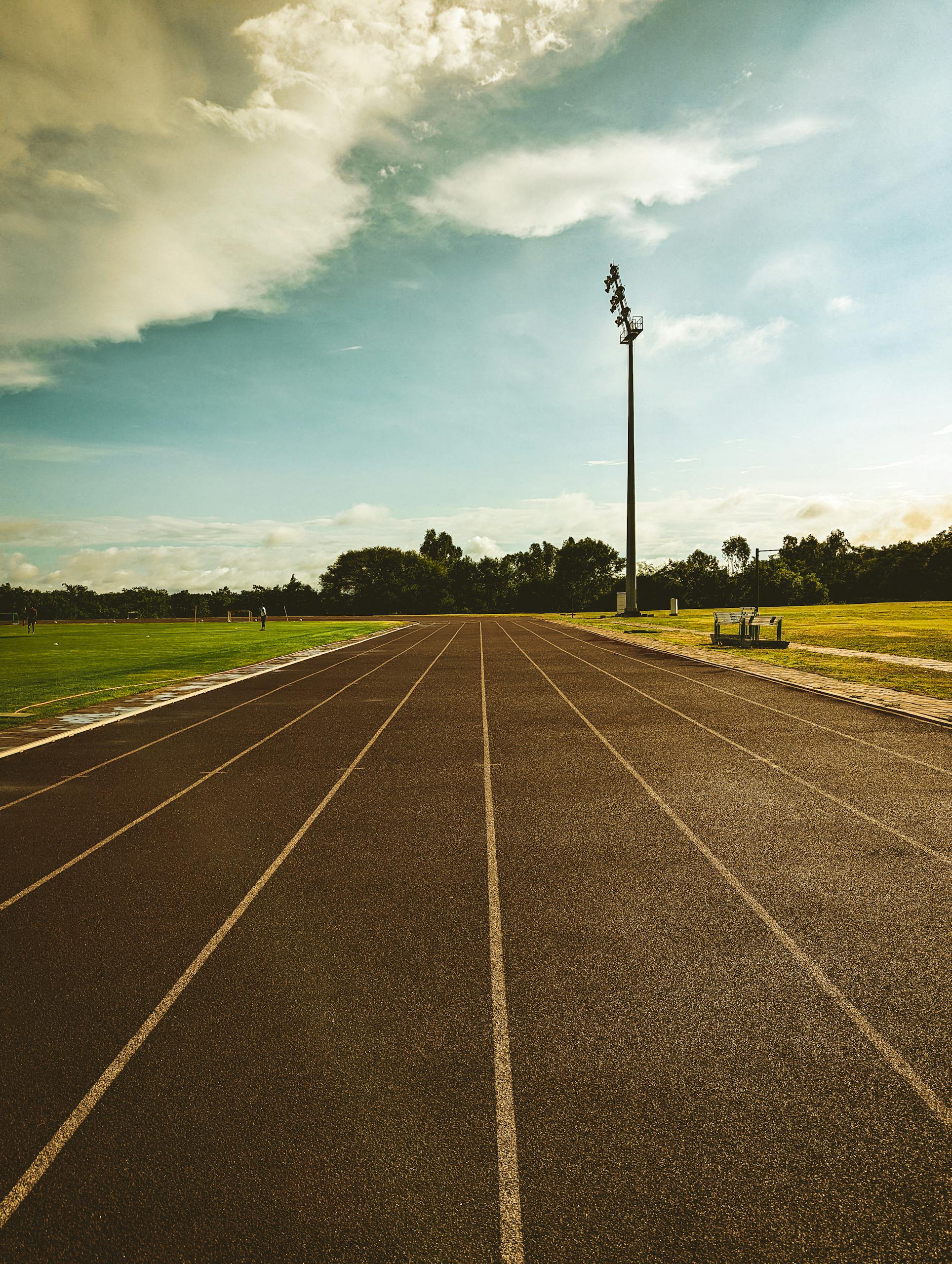 A vibrant outdoor running track on a sunny day, perfect for athletics.