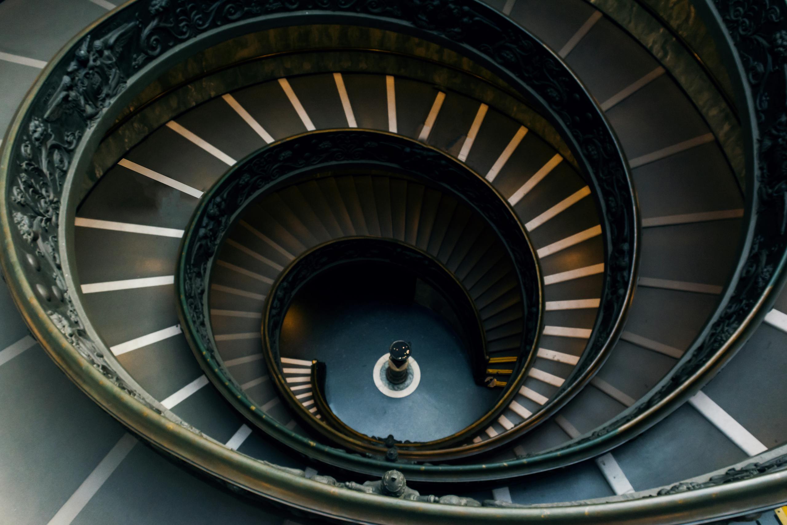 A stunning view of the iconic Bramante Staircase's spiral design in Vatican Museums, Rome.