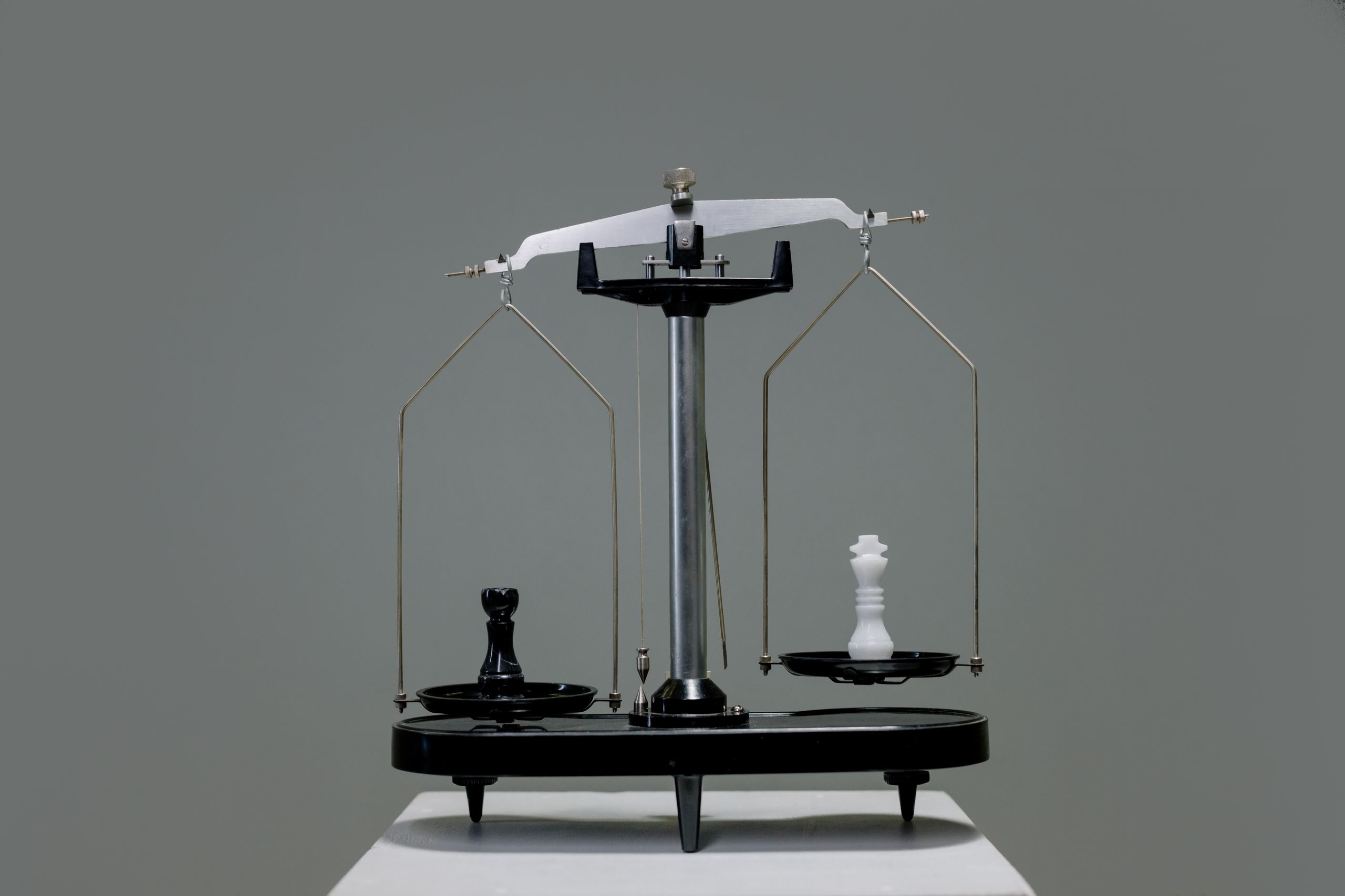 Chess pieces balanced on a scale depicting equality or strategy in decision making.